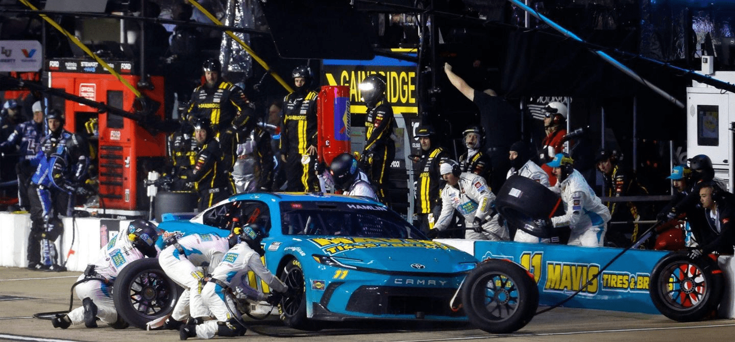 Denny Hamlin stops for fuel and tyres. JGHPI estimates that NASCAR pitstops are 10 times more impactful than F1 pitstops.