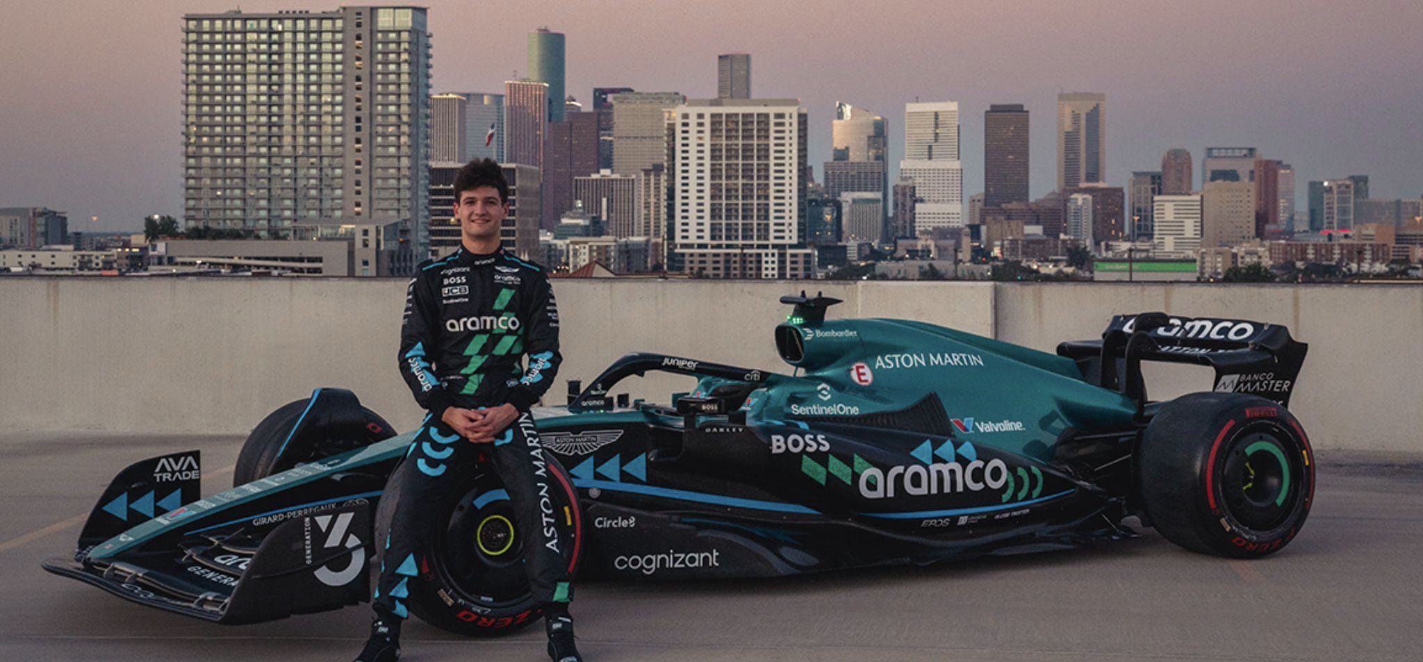 Jak Crawford standing in front of Aston Martin AMR22 F1 car