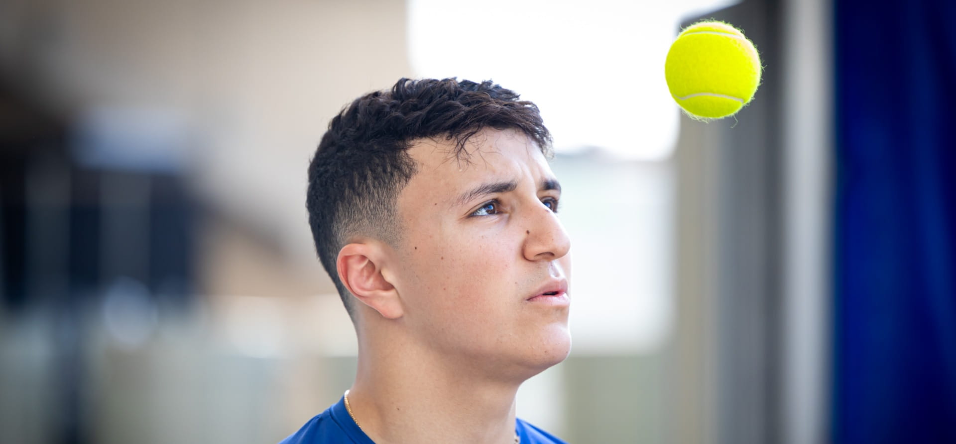 Isack Hadjar throwing a tennis ball