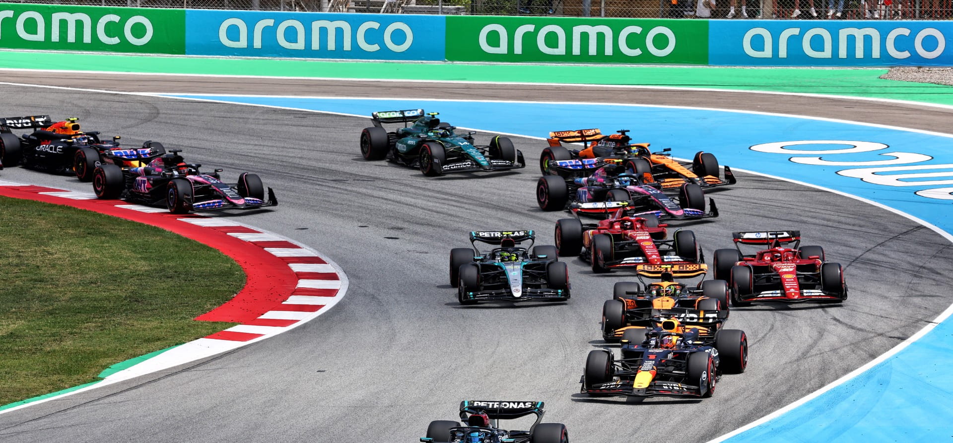 The start of the 2024 Spanish Grand Prix with numerous cars going through a corner
