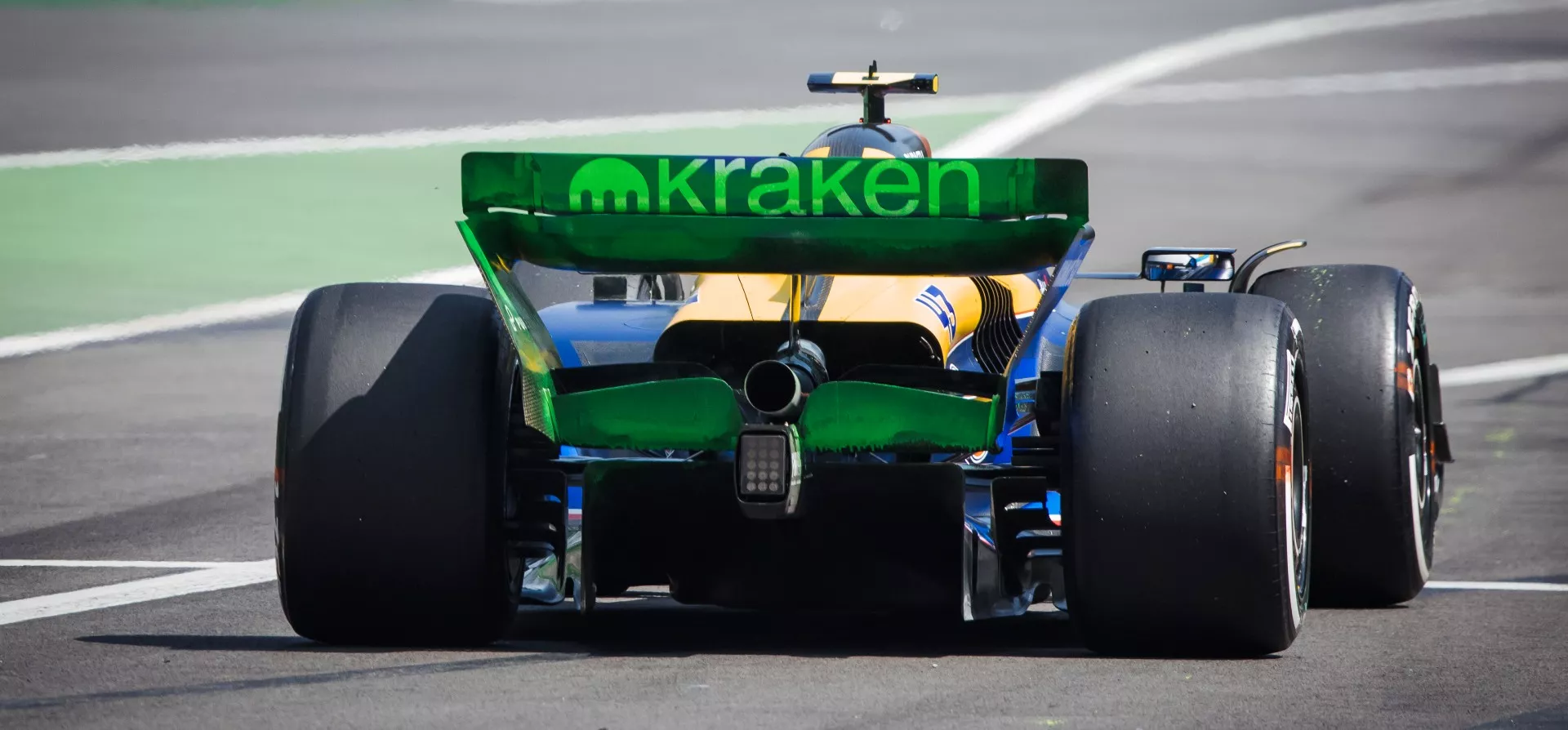 The rear of the 2024 Williams F1 car with fluorescent flow-vis paint in green on the rear wing