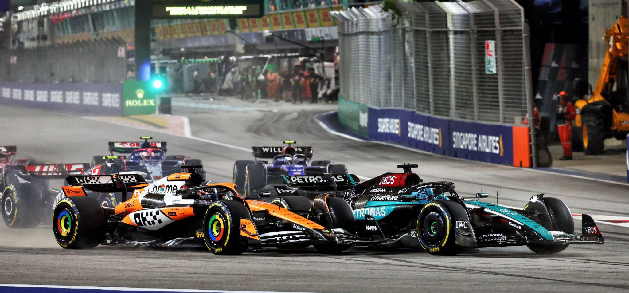 start of 2024 Singapore Grand Prix, with an orange McLaren racing a silver Mercedes