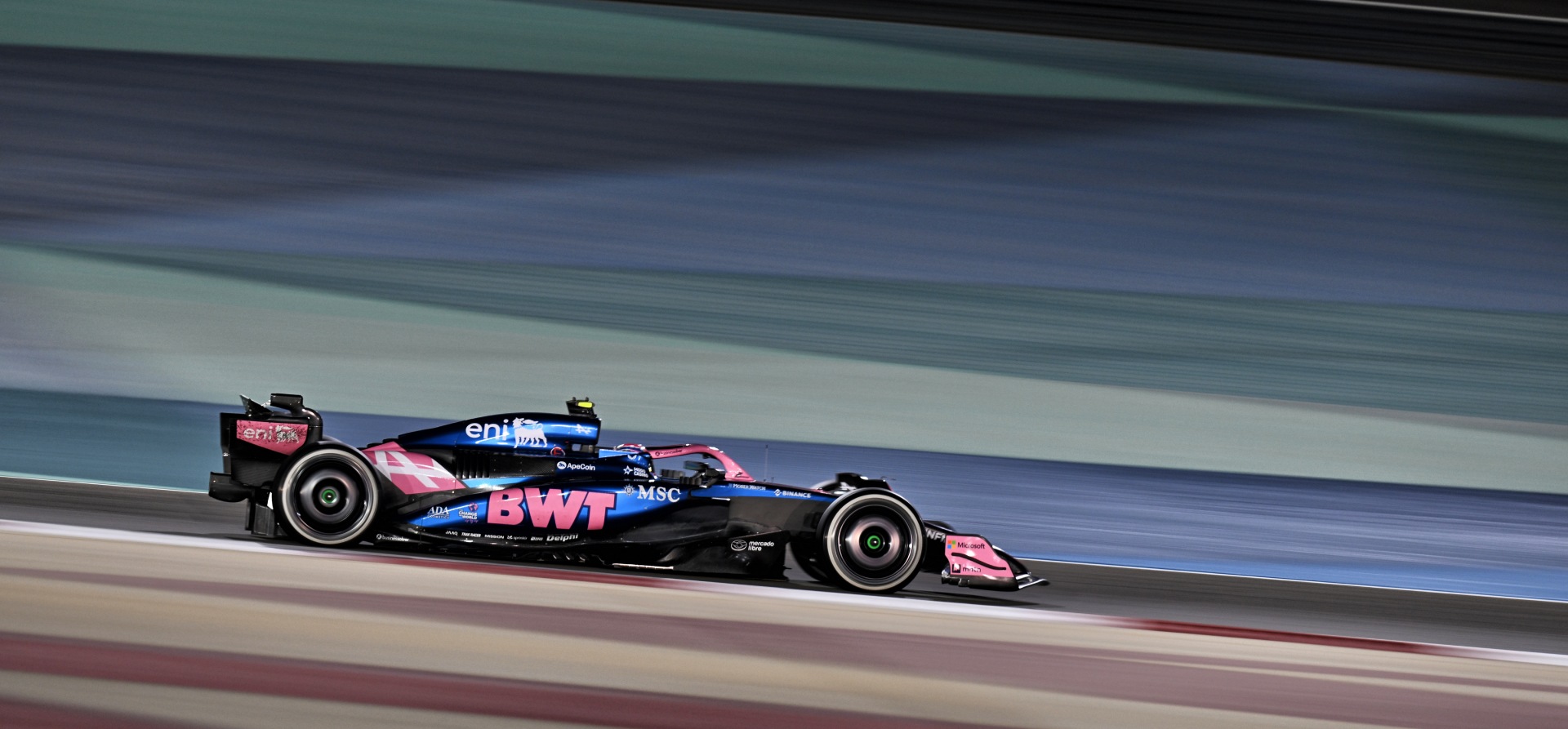 Blue and pink Alpine A525 F1 car under the lights in Bahrain 2025 F1 pre-season testing
