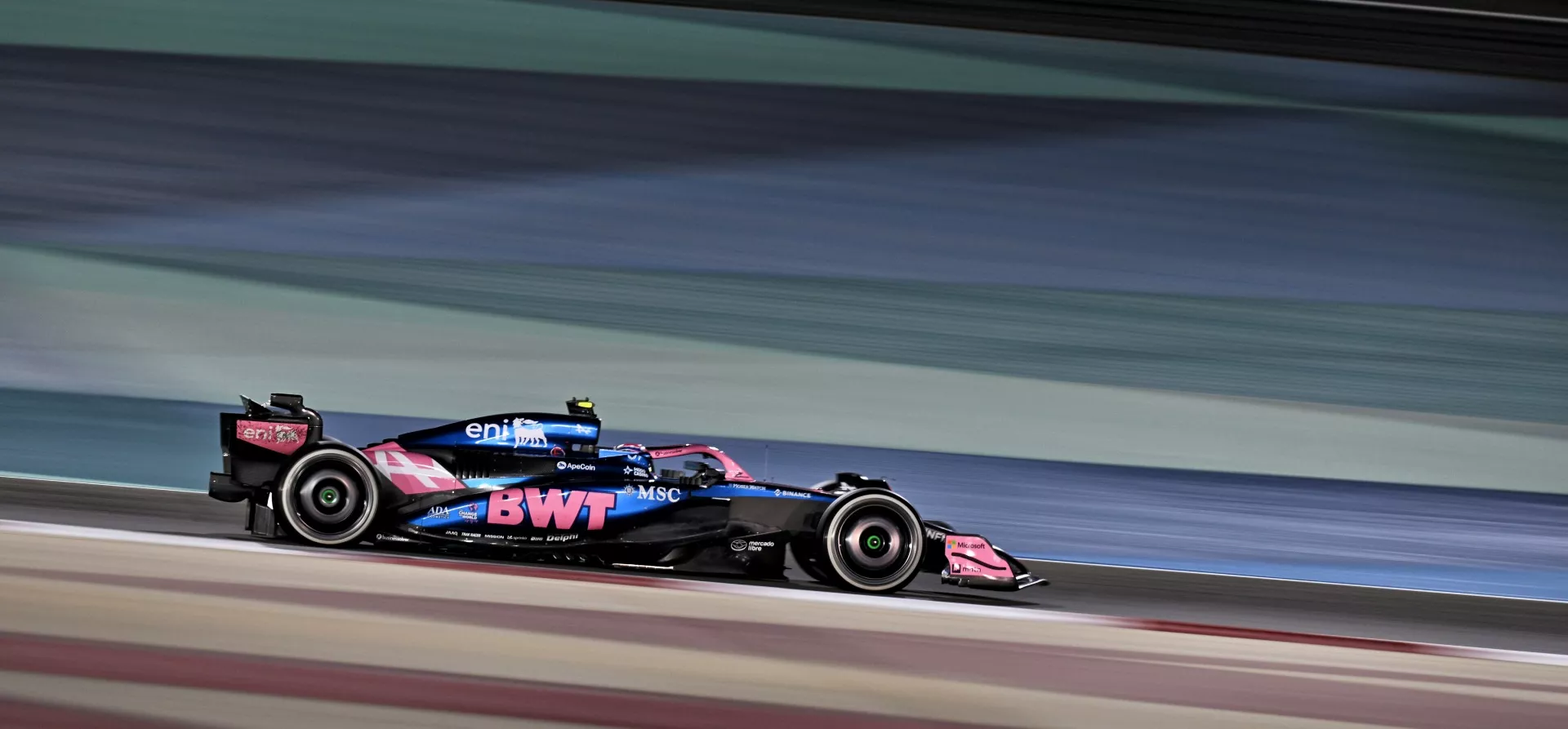 Blue and pink Alpine A525 F1 car under the lights in Bahrain 2025 F1 pre-season testing
