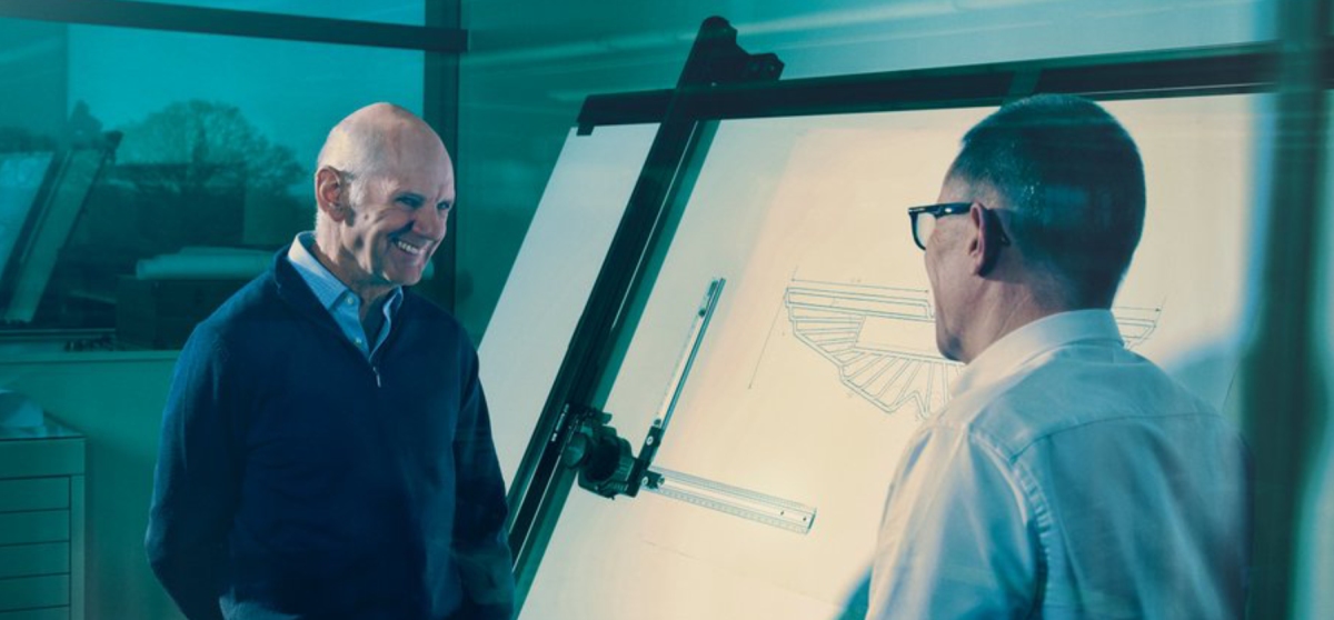 Adrian Newey and Andy Cowell standing in front of a whiteboard