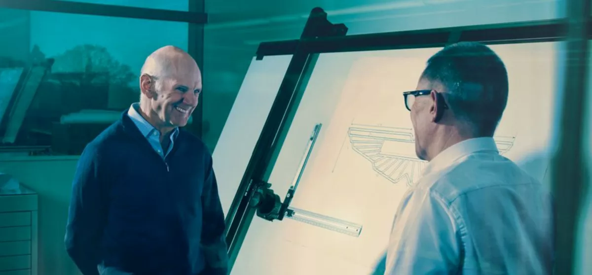 Adrian Newey and Andy Cowell standing in front of a whiteboard