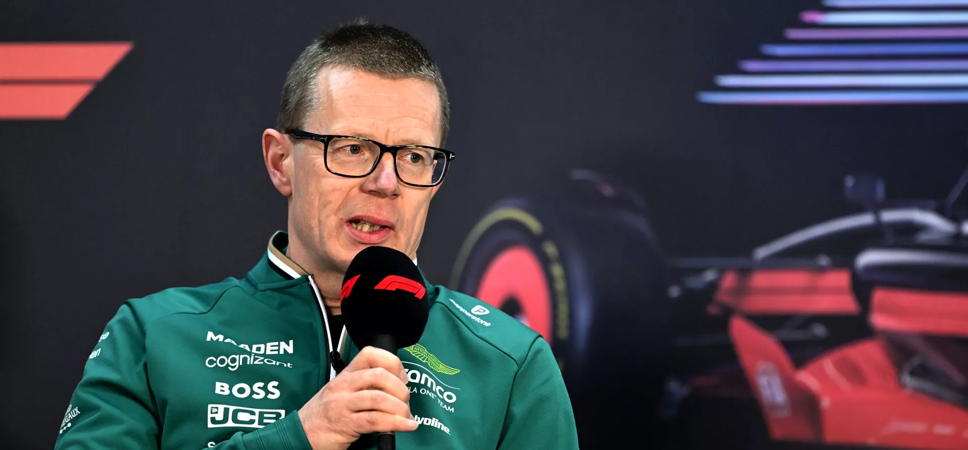 Andy Cowell, Aston Martin team boss, holding a microphone