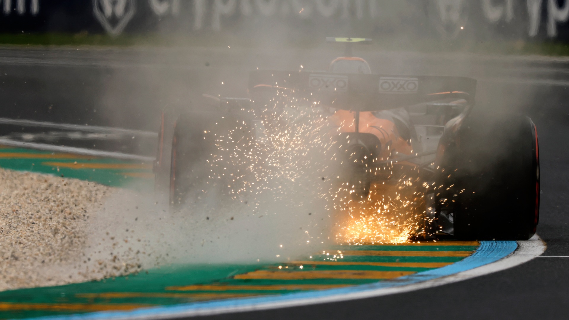 Rear of 2025 McLaren F1 car with sparks flying