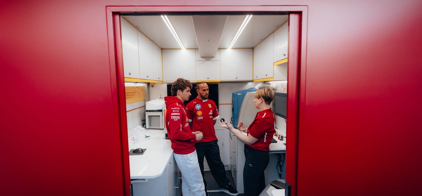 Lewis HAmilton and Charles Leclerc at Shell F1 trackside lab
