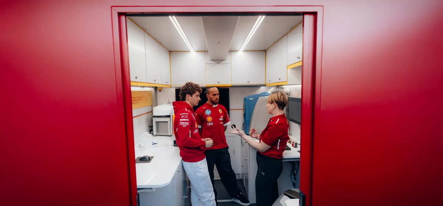 Lewis HAmilton and Charles Leclerc at Shell F1 trackside lab