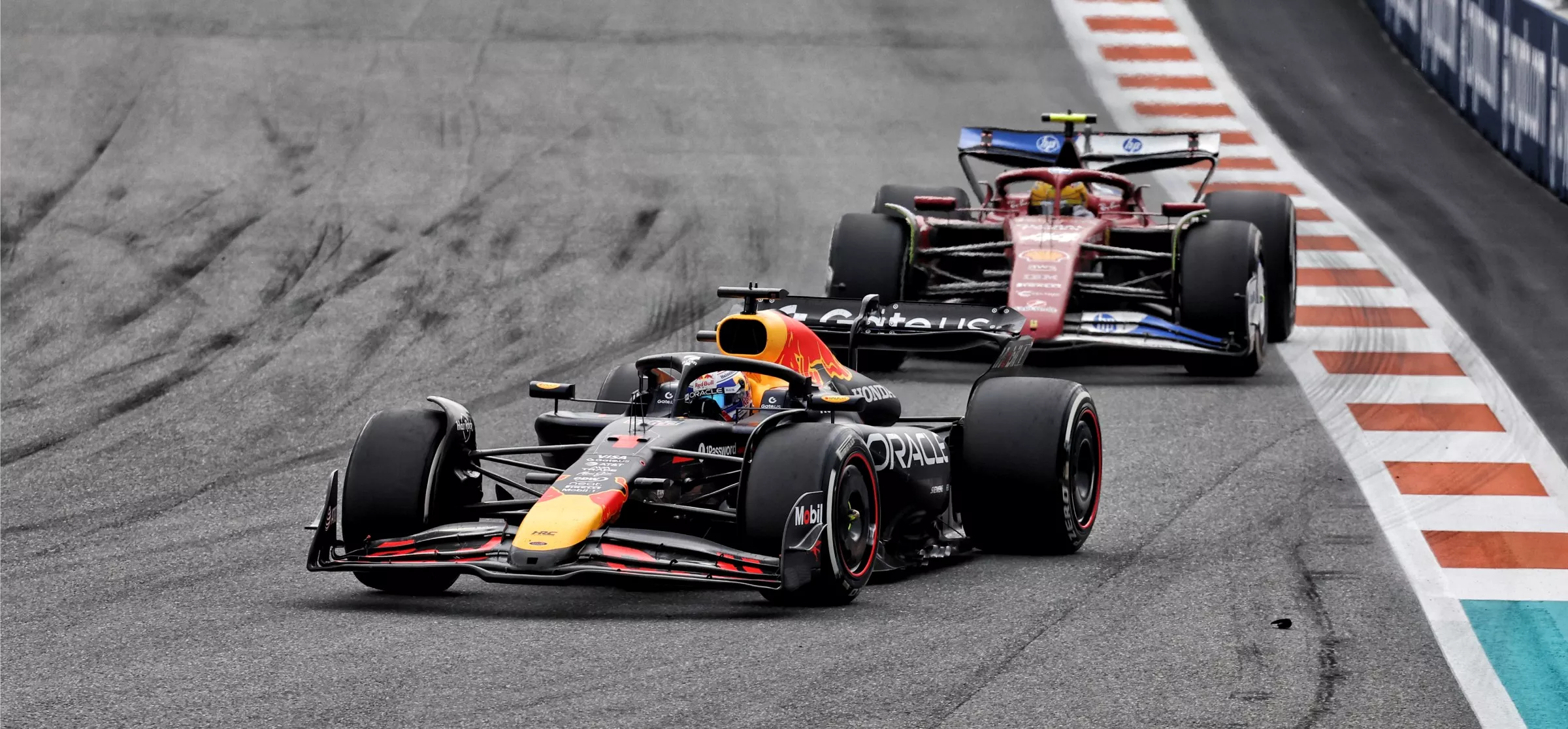 Ferrari F1 car following red Bull F1 car