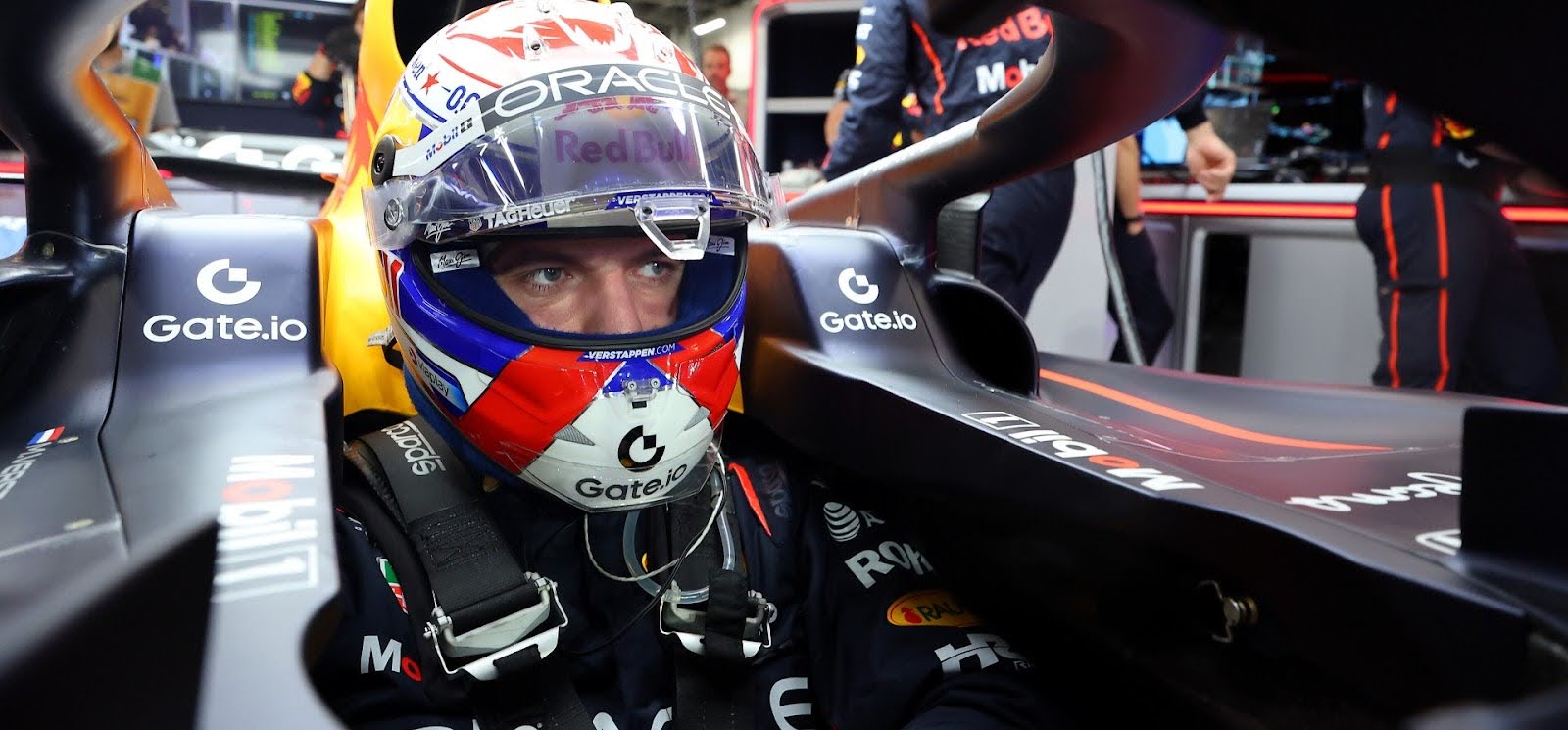 Max Verstappen sitting in Red Bull car cockpit