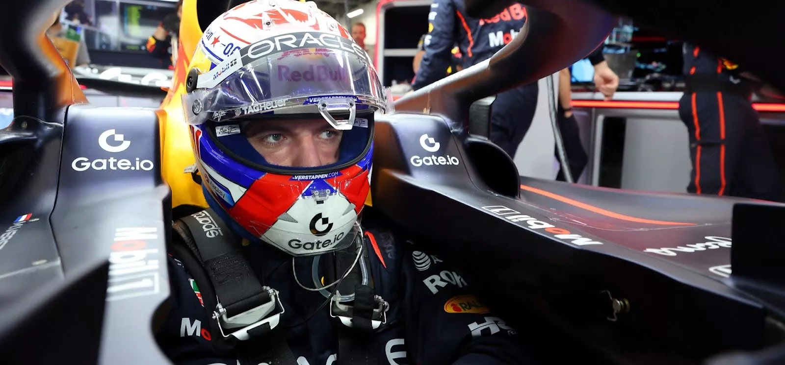 Max Verstappen sitting in Red Bull car cockpit