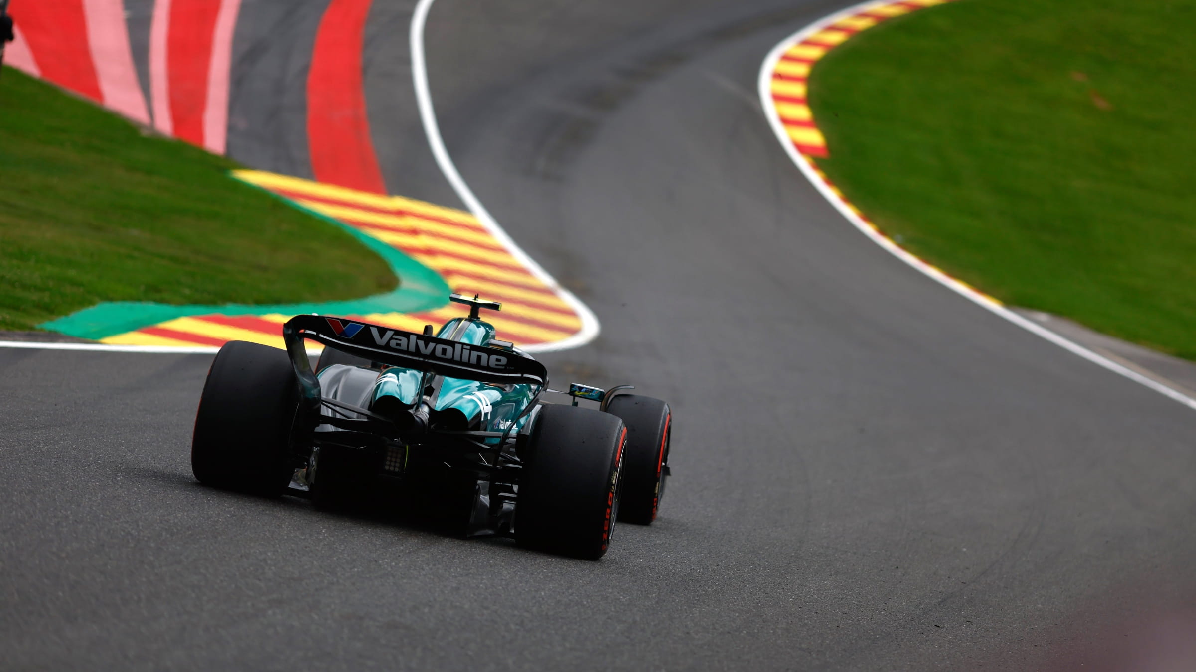 Aston martin F1 car going up Eau Rouge in 2024