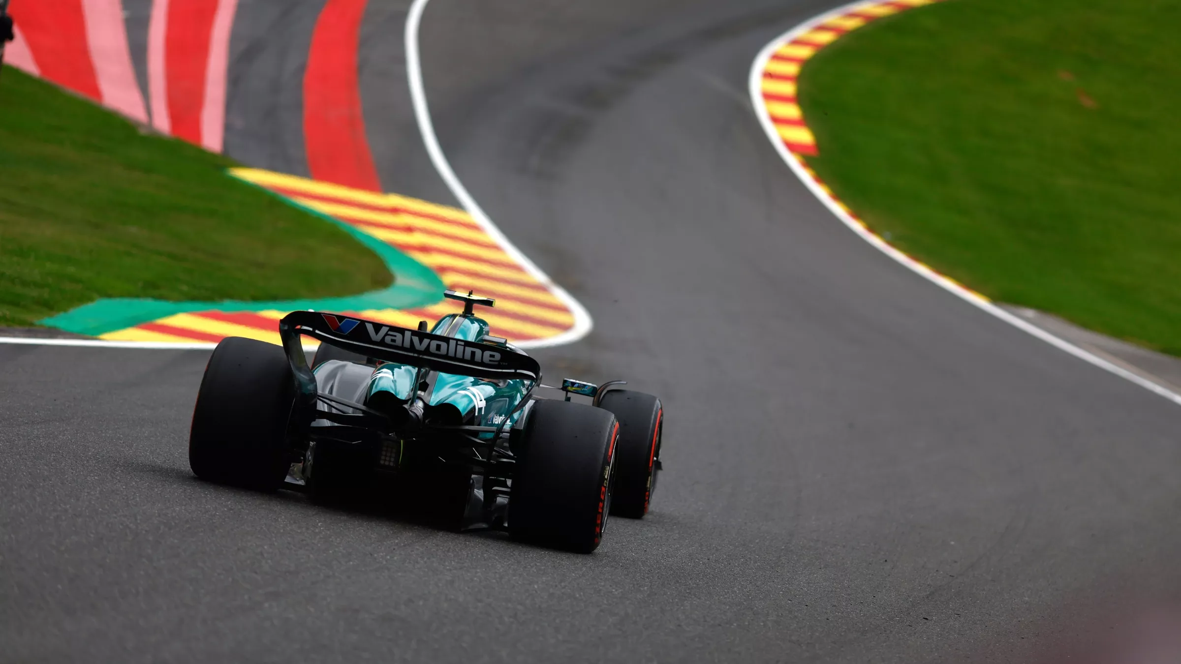 Aston martin F1 car going up Eau Rouge in 2024
