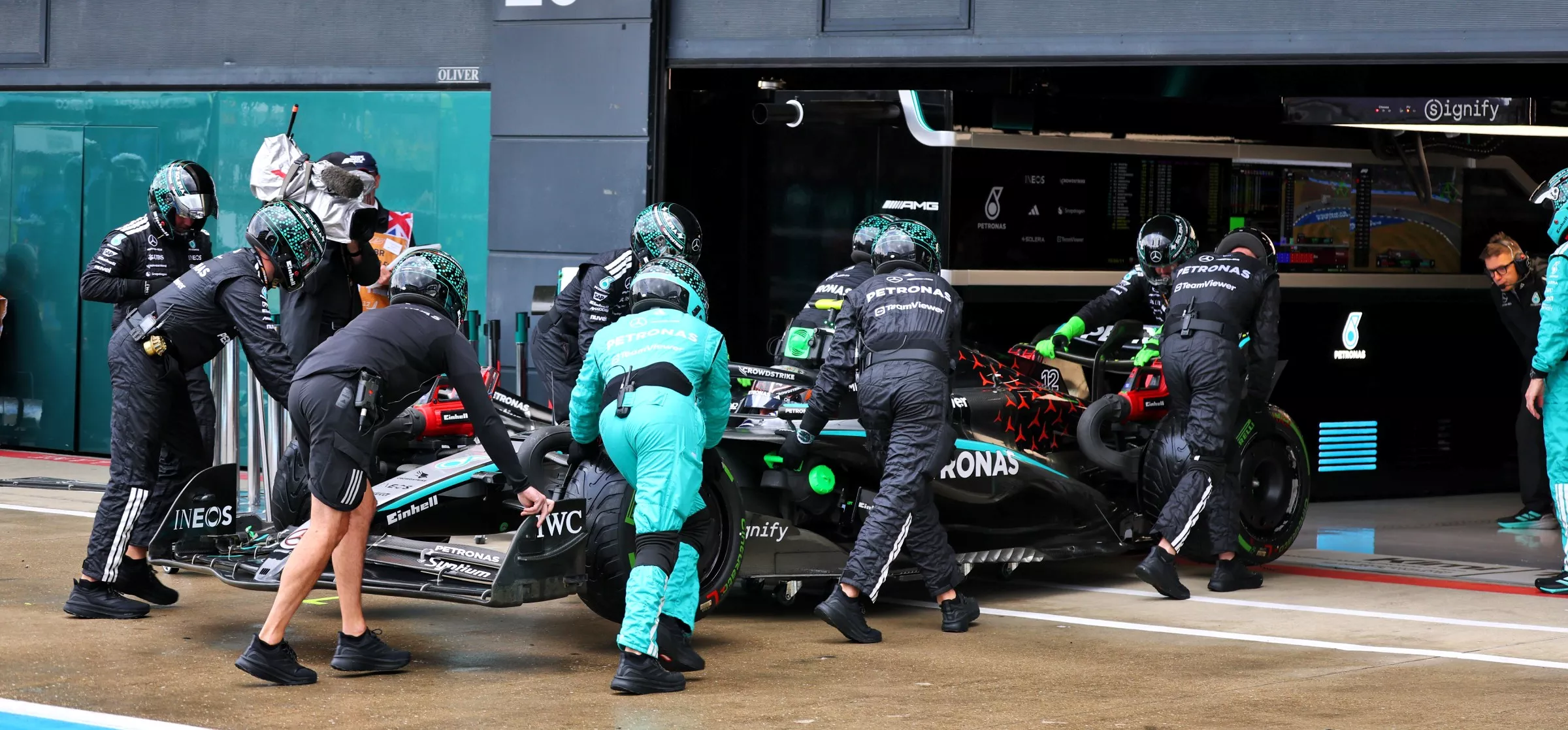 Car being wheeled into garage at the 2025 British GP