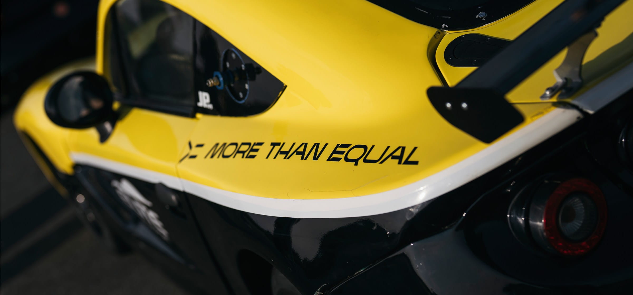 Ginetta racing car with more than equal sticker