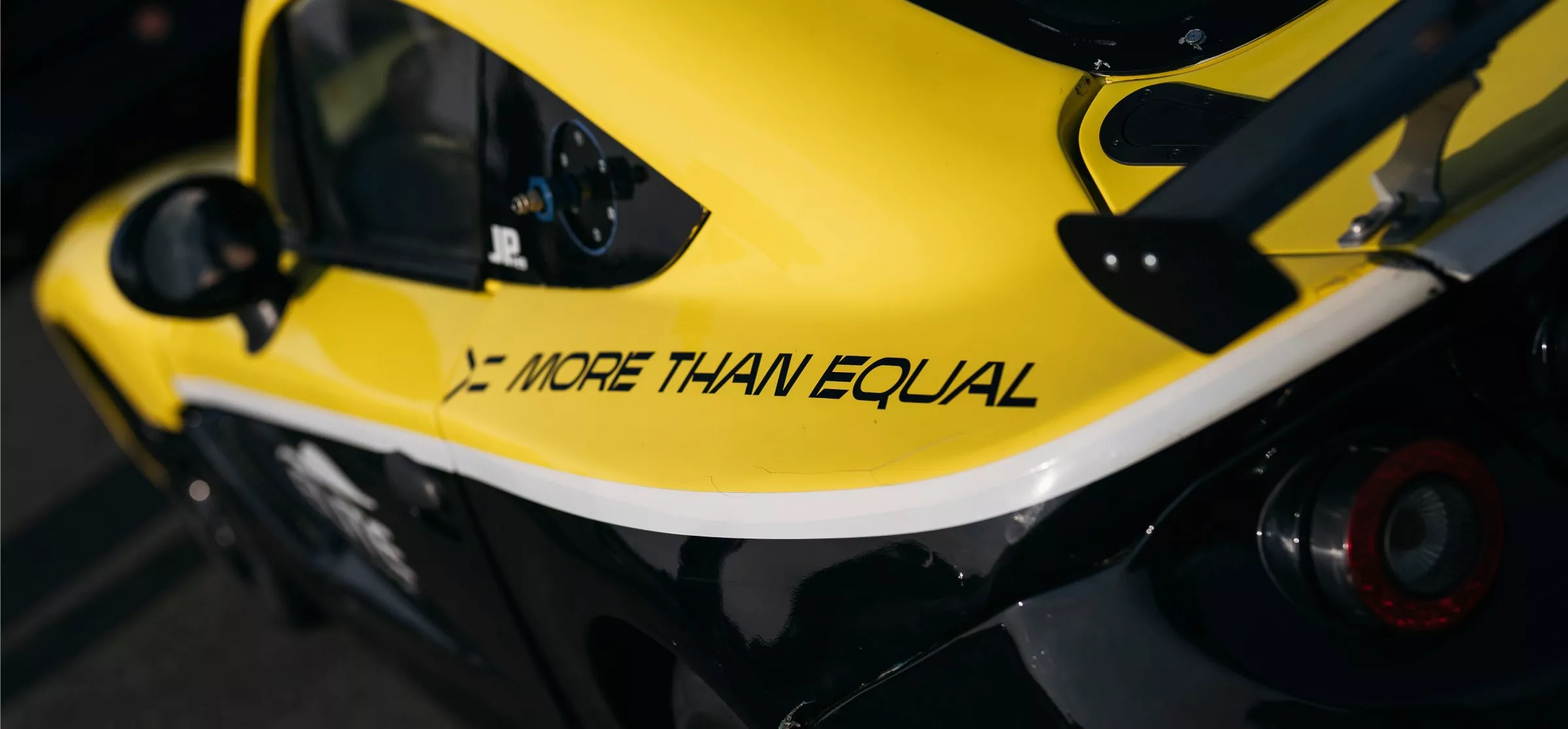 Ginetta racing car with more than equal sticker