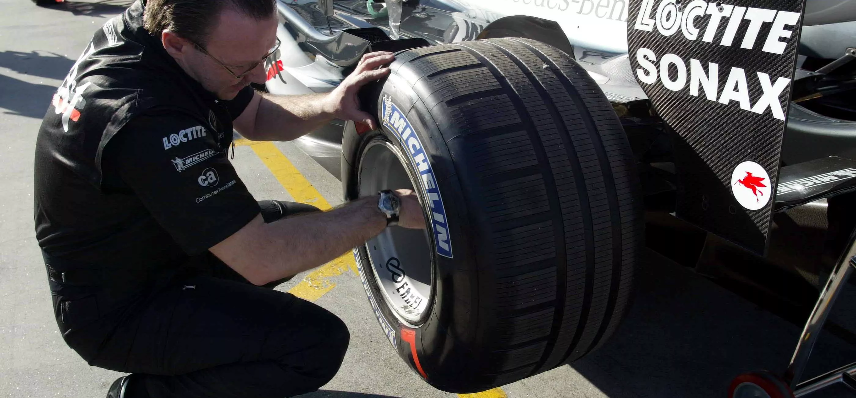 A grooved Michelin tyre being fitted to a McLaren at the 2003 Australian Grand Prix