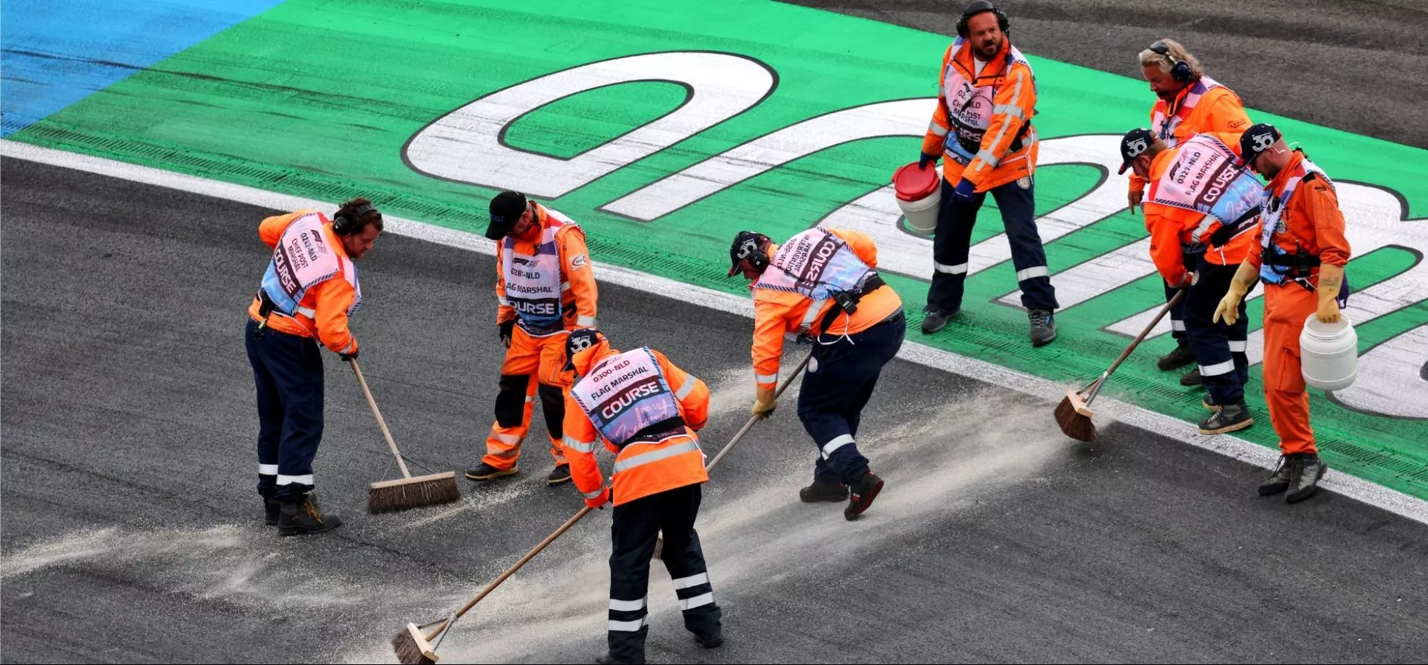 Volunteers sweep the Zandvoort circuit during the 2025 Dutch Grand Prix weekend